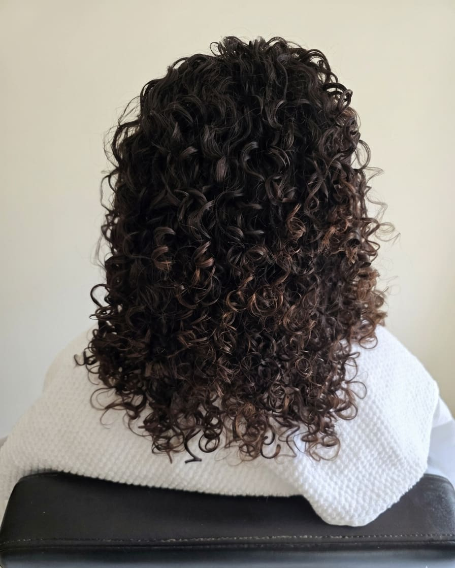 Clean, lightweight curls restored to their natural spring.