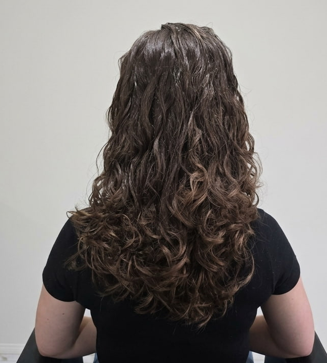 Glossy, sculpted curls radiating confidence and care.