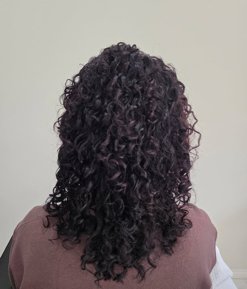 Soft, radiant curls embracing their natural pattern.