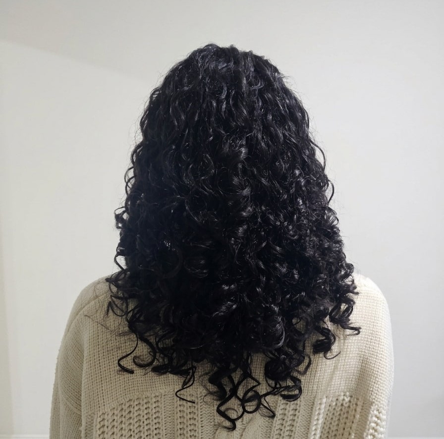 Deeply conditioned curls glowing with health and definition.