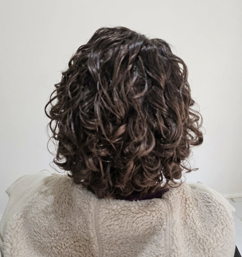 Soft, radiant curls embracing their natural pattern.