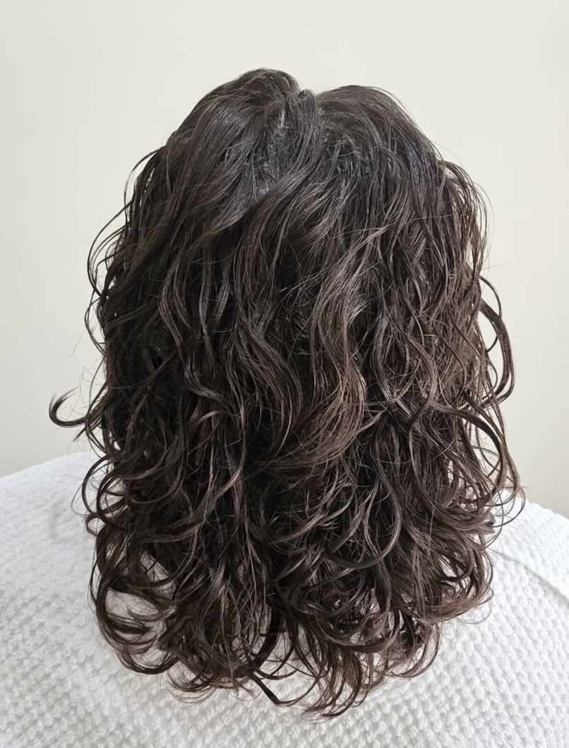 Defined curls with enhanced shape, volume, and movement from root to end.